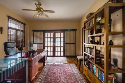 a room with a desk and a book shelf at Luxury Pool Villa by Golf Courses & Elephant Sanctuary in Kathu