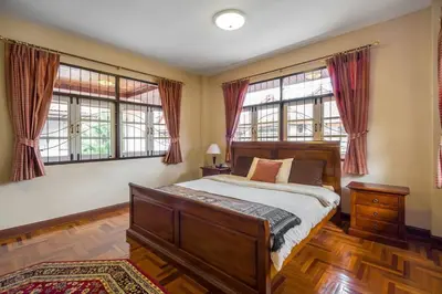 a bedroom with a bed and two windows at Luxury Pool Villa by Golf Courses & Elephant Sanctuary in Kathu