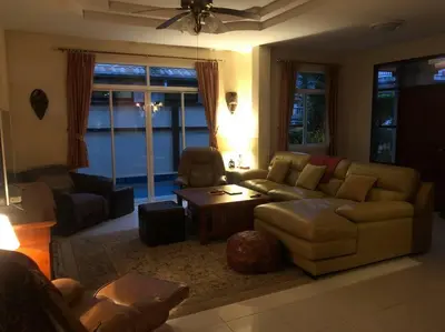 a living room with a couch and a table at Luxury Pool Villa by Golf Courses & Elephant Sanctuary in Kathu