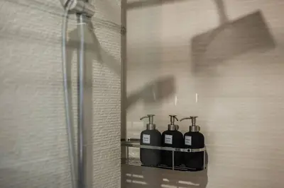 a group of four bottles on a shelf in a shower at C201 Neatest Apartment The title 50m to beach and shops in Rawai Beach