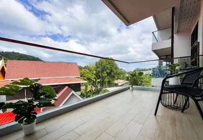a balcony with a view of a building at Cozy 1BR Apartment with Big Balcony - 2 Pools & 5 mins from Surin Beach in Phuket Town