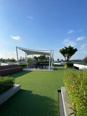 a gazebo with a table in a field of grass at Studio Apartment, Bang Tao Phuket in Laguna Phuket