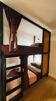a mirror in a room with two bunk beds at Brightstar Hostel in Phi Phi Don