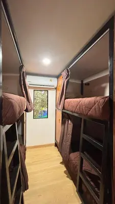 a room with two bunk beds and a window at Brightstar Hostel in Phi Phi Don