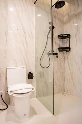 a bathroom with a toilet and a shower at Karen Sunset Hotel in Phuket Town