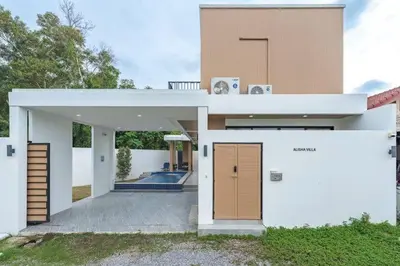 a large white house with a door in front of it at V149 La bella villa Brand New Fully Luxury in Bang Tao Beach