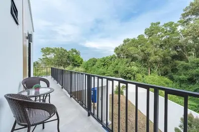a balcony with two chairs and a table with a view at V149 La bella villa Brand New Fully Luxury in Bang Tao Beach