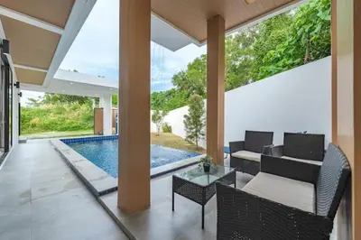 a patio with a pool and chairs and a table at V149 La bella villa Brand New Fully Luxury in Bang Tao Beach