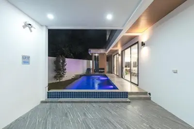 a swimming pool in the side of a house at V149 La bella villa Brand New Fully Luxury in Bang Tao Beach