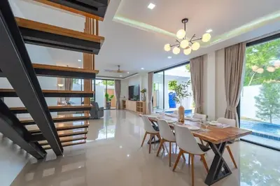 a dining room with a wooden table and chairs at V149 La bella villa Brand New Fully Luxury in Bang Tao Beach