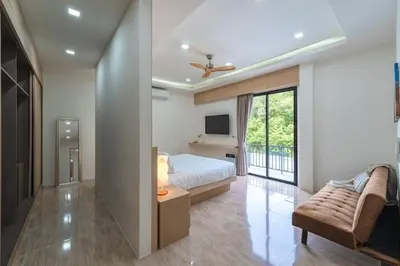 a bedroom with a bed and a couch and a tv at V149 La bella villa Brand New Fully Luxury in Bang Tao Beach