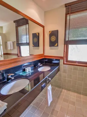 a bathroom with two sinks and a mirror at Happy villa in Laguna in Layan Beach