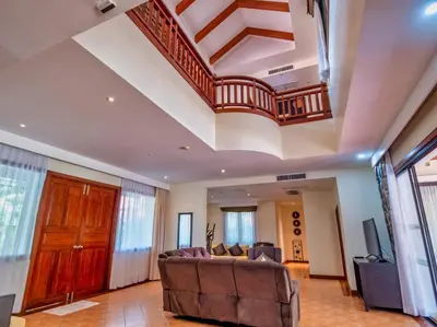 a living room with a couch and a staircase at Happy villa in Laguna in Layan Beach