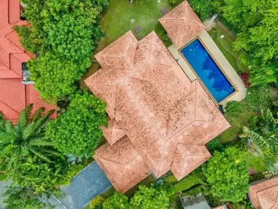an overhead view of a swimming pool and trees at Happy villa in Laguna in Layan Beach