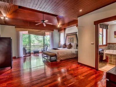 a master bedroom with a bed and a balcony at Happy villa in Laguna in Layan Beach