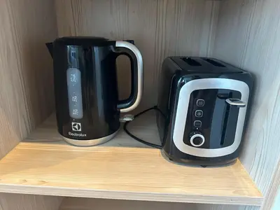 two coffins and a toaster sitting on a shelf at Diamond Resort Phuket Condo Bang Tao Beach in Thalang