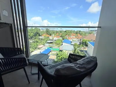 a balcony with chairs and a view of a pool at Diamond Resort Phuket Condo Bang Tao Beach in Thalang