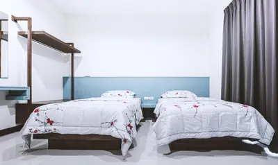 two beds sitting next to each other in a bedroom at Ra Residence Phuket in Chalong