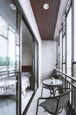 a balcony with a table and chairs and a bed at Ra Residence Phuket in Chalong