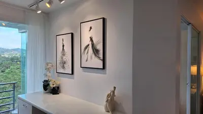a room with three pictures on the wall at Plus condo 2 kathu by Tida in Kathu