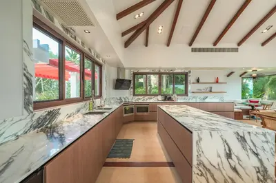 a large kitchen with marble counter tops and windows at V151 Nicest Villa With The Best Views In Phuket in Thalang