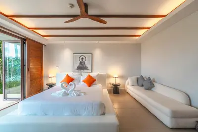a bedroom with a large white bed and a couch at V151 Nicest Villa With The Best Views In Phuket in Thalang