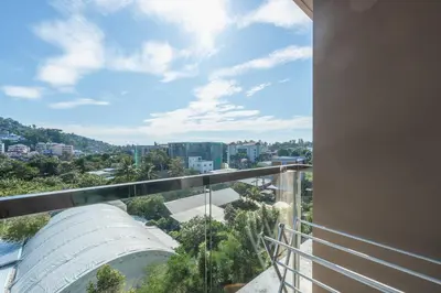 a balcony with a view of a city at C153 The Aristo Luxury Beach Resort Phuket in Thalang