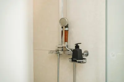 a shower with a hair dryer and a mirror at C153 The Aristo Luxury Beach Resort Phuket in Thalang
