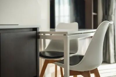 a desk with two white chairs next to a table at C153 The Aristo Luxury Beach Resort Phuket in Thalang