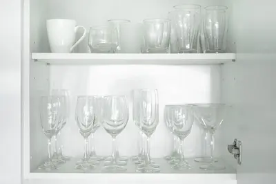 a row of wine glasses on a shelf at ELEGANT Kata sea View Apartmens in Kata Beach