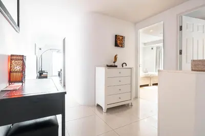 a white room with a dresser and a mirror at ELEGANT Kata sea View Apartmens in Kata Beach