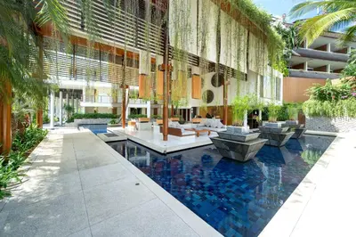 a lobby with a pool in the middle of a building at Luxury Flat 2BR at CHAVA 5-Star Resort in Surin Beach