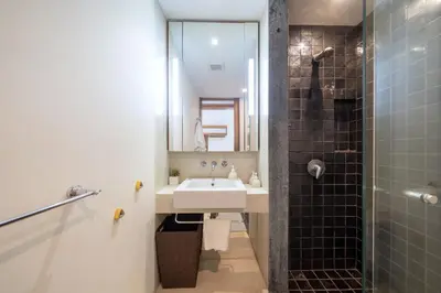 a bathroom with a sink and a shower at Luxury Flat 2BR at CHAVA 5-Star Resort in Surin Beach
