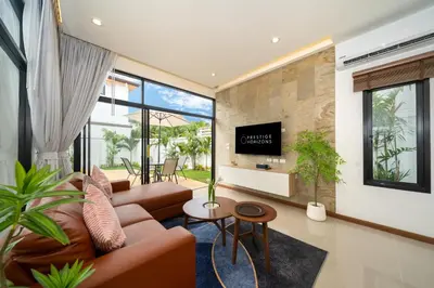 a living room with a couch and a tv at Goldena Twin Private Pool Villas in Kamala Beach