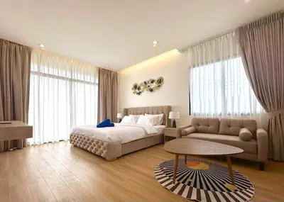 a bedroom with a bed and a couch and a table at Goldena Twin Private Pool Villas in Kamala Beach