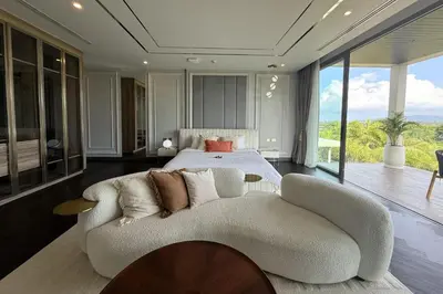 a bedroom with a white couch and a bed at Villa Lion Phuket in Phuket