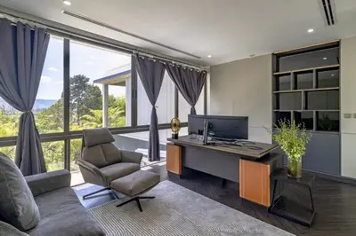 an office with a desk with a computer and a chair at Villa Lion Phuket in Phuket