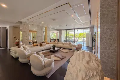 a living room with a large couch and chairs at Villa Lion Phuket in Phuket