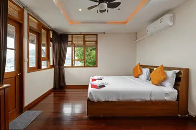 a bedroom with a bed and a ceiling fan at Villa Moon Talay Panorama View in Patong Beach