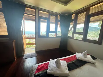 a bedroom with a bed with two towels on it at Villa Moon Talay Panorama View in Patong Beach
