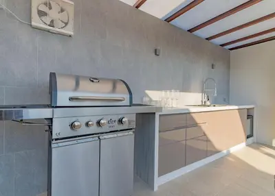 a kitchen with a stove and a sink at Infinite Ocean Retreats at Angsana Oceanview in Laguna Phuket