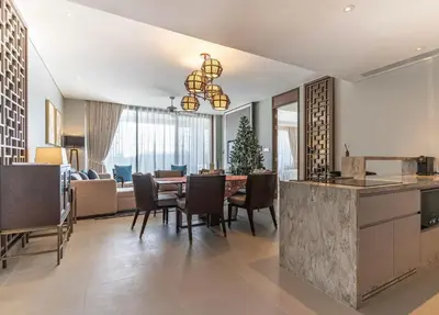 a kitchen and dining room with a table and chairs at Infinite Ocean Retreats at Angsana Oceanview in Laguna Phuket