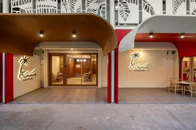 an entrance to a store with palm trees on the wall at Summer Sea Phi Phi Island in Phi Phi Don