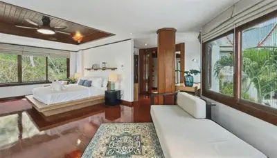 a bedroom with a bed and a couch and windows at Luxury Seaview 6 Bedrooms with Infinity Pool Villa, private Gym, Superfast WIFI in Surin Beach