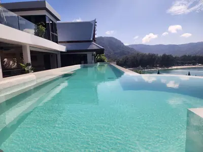 a large swimming pool in front of a building at Luxury Seaview 6 Bedrooms with Infinity Pool Villa, private Gym, Superfast WIFI in Surin Beach