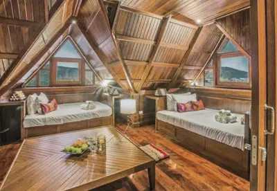 a room with two beds and a table in it at Luxury Seaview 6 Bedrooms with Infinity Pool Villa, private Gym, Superfast WIFI in Surin Beach