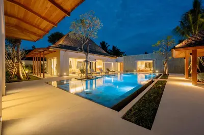 an image of a villa with a swimming pool at night at Spacious 4BR Private 15m Pool Villa Anchan V10 in Gated Residence in Bang Tao Beach