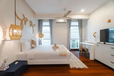 a bedroom with a white bed and a desk at Seaside Bliss Beach Villa Rawai in Rawai Beach