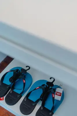 two pairs of flip flops sitting on a table at Seaside Bliss Beach Villa Rawai in Rawai Beach