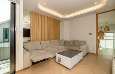 a living room with a couch and a table at Bangtao Pool Villa with Home Cinema - PrymaVista in Phuket